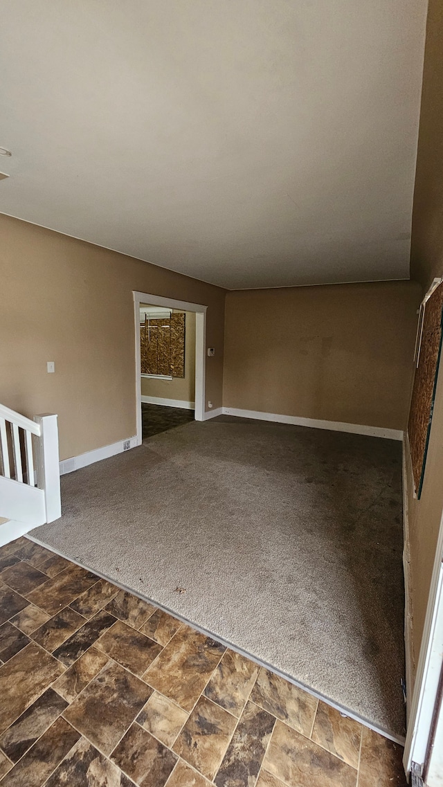 4107 N Campbell St, Detroit, MI 48210 - carpeted empty room with baseboards and stone finish flooring