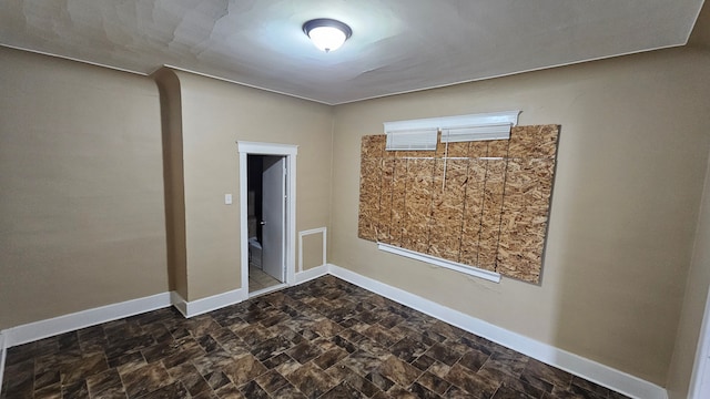 4107 N Campbell St, Detroit, MI 48210 - spare room featuring baseboards and stone finish flooring
