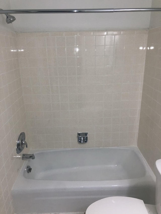 bathroom with toilet and shower / bathing tub combination