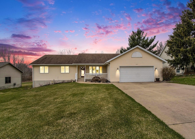 single story home featuring a porch, an attached garage, concrete driveway, and a front yard