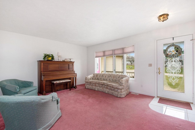 tiled living area with carpet flooring, visible vents, and baseboards