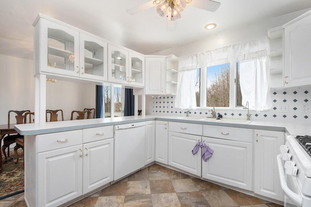 kitchen with a ceiling fan, open shelves, gas range, decorative backsplash, and white dishwasher