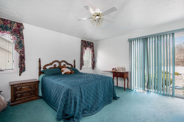 bedroom with a textured ceiling, access to exterior, ceiling fan, and carpet