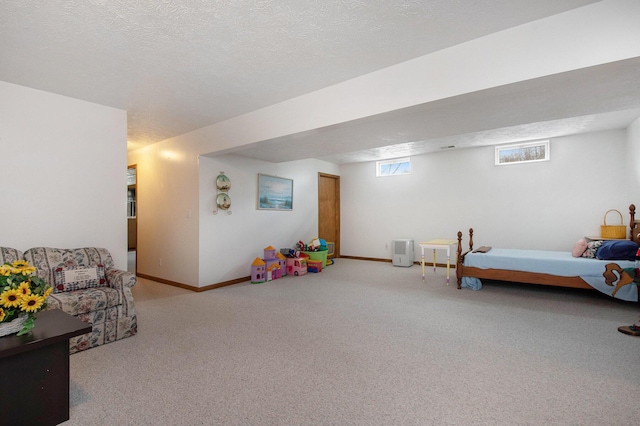 carpeted bedroom featuring a textured ceiling and baseboards