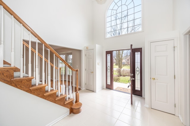 5521 Lohr Lake Dr, Ann Arbor, MI 48108 - entrance foyer featuring baseboards, a towering ceiling, stairway, and light tile patterned floors
