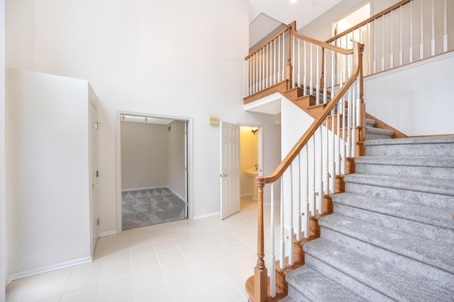 5521 Lohr Lake Dr, Ann Arbor, MI 48108 - staircase with a high ceiling and baseboards