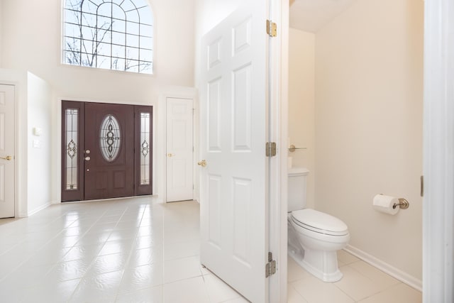 5521 Lohr Lake Dr, Ann Arbor, MI 48108 - entrance foyer featuring light tile patterned floors, baseboards, and a towering ceiling