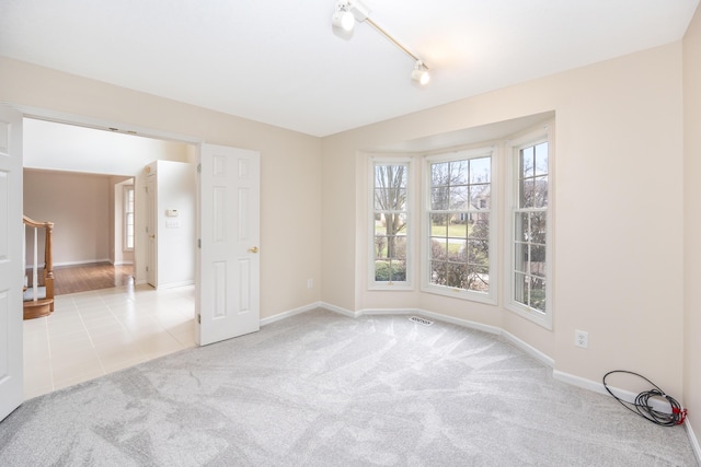 5521 Lohr Lake Dr, Ann Arbor, MI 48108 - carpeted spare room featuring stairs, baseboards, and rail lighting