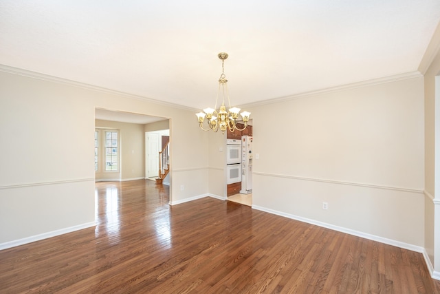 5521 Lohr Lake Dr, Ann Arbor, MI 48108 - spare room featuring a chandelier, ornamental molding, wood finished floors, baseboards, and stairway