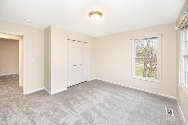 5521 Lohr Lake Dr, Ann Arbor, MI 48108 - unfurnished bedroom with carpet, a closet, and baseboards