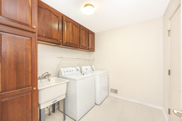 5521 Lohr Lake Dr, Ann Arbor, MI 48108 - laundry room featuring separate washer and dryer, cabinet space, and baseboards