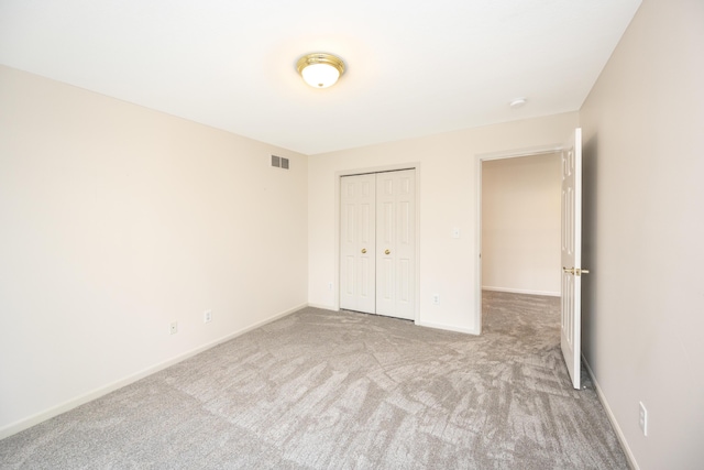 5521 Lohr Lake Dr, Ann Arbor, MI 48108 - unfurnished bedroom with carpet flooring, a closet, and baseboards
