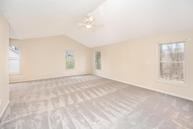 5521 Lohr Lake Dr, Ann Arbor, MI 48108 - carpeted empty room with a ceiling fan, lofted ceiling, baseboards, and healthy amount of natural light