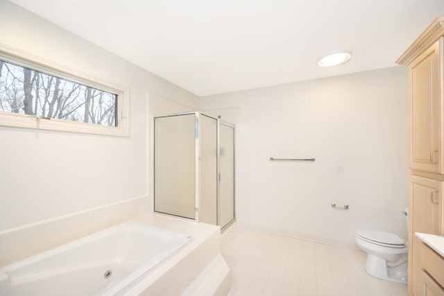 5521 Lohr Lake Dr, Ann Arbor, MI 48108 - bathroom featuring a garden tub, vanity, a shower stall, toilet, and tile patterned floors