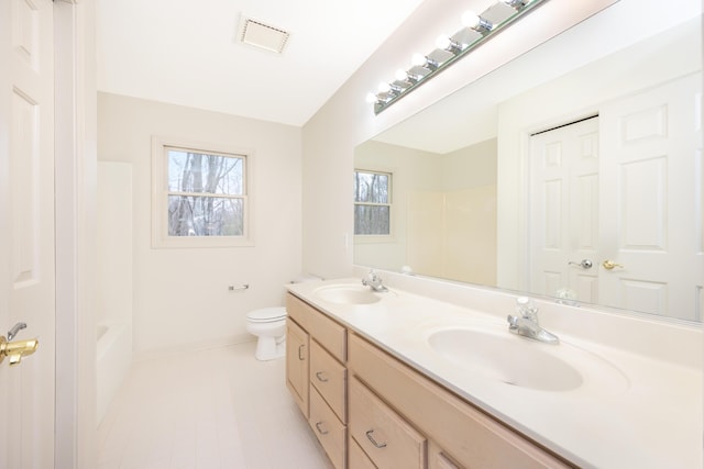 5521 Lohr Lake Dr, Ann Arbor, MI 48108 - full bathroom with double vanity, baseboards, toilet, and  shower combination