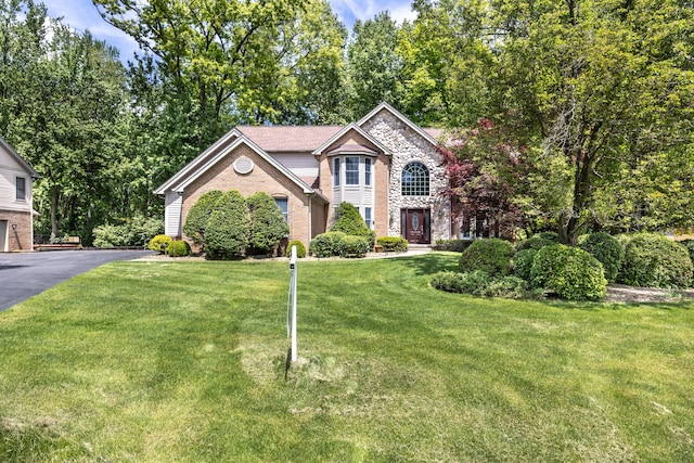 5521 Lohr Lake Dr, Ann Arbor, MI 48108 - view of front of property featuring brick siding, a front lawn, and stone siding