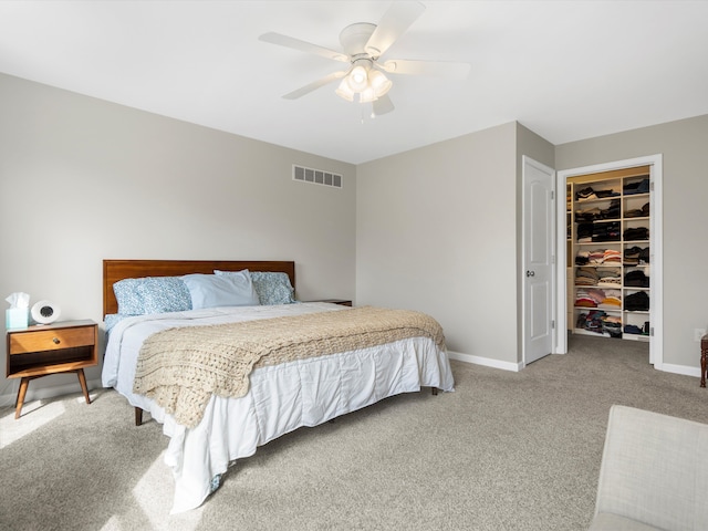 carpeted bedroom with a ceiling fan, baseboards, a closet, and visible vents
