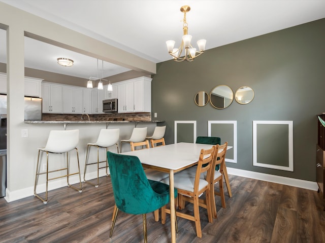 dining area with baseboards, a chandelier, and dark wood-type flooring