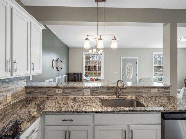 kitchen with white cabinetry, tasteful backsplash, a healthy amount of sunlight, and a sink