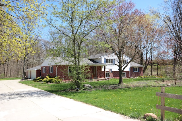 64050 Limerick Ln, Washington, MI 48095 - view of front of house featuring concrete driveway, a front lawn, and brick siding