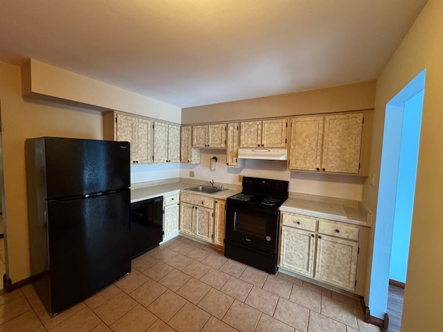 kitchen with under cabinet range hood, a sink, black appliances, and light countertops