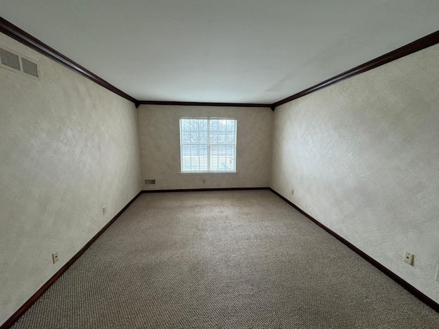 unfurnished room with crown molding, carpet flooring, and visible vents