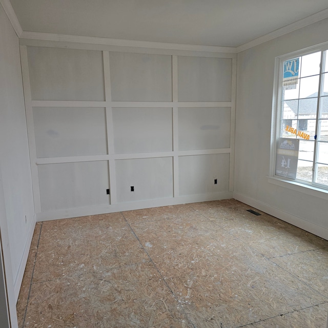 unfurnished room featuring visible vents and ornamental molding