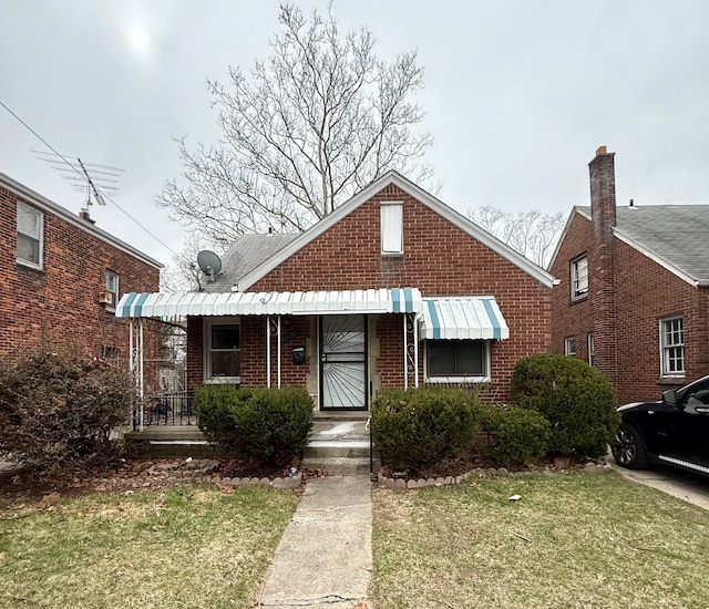 18655 Strasburg St, Detroit, MI 48205 - bungalow featuring a front yard and brick siding