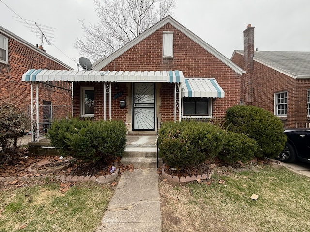 18655 Strasburg St, Detroit, MI 48205 - view of front of home featuring a porch and brick siding