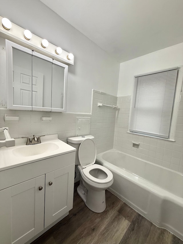 18655 Strasburg St, Detroit, MI 48205 - full bath with a bathing tub, tile walls, toilet, vanity, and wood finished floors