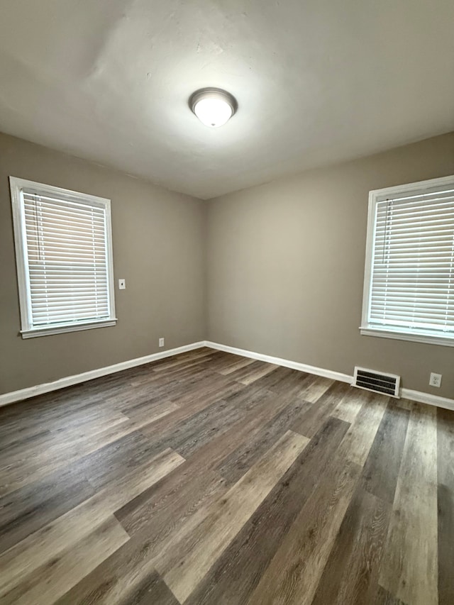 18655 Strasburg St, Detroit, MI 48205 - empty room featuring visible vents, baseboards, and dark wood finished floors