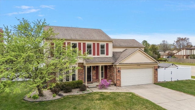 view of front of home with a front yard, a garage, driveway, brick siding, and fence