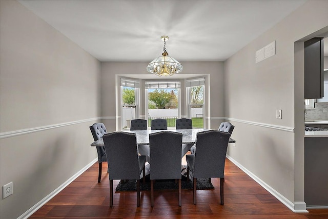 dining room with a chandelier, visible vents, dark wood-style floors, and baseboards