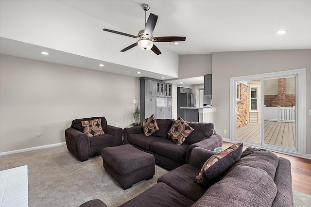 living room with baseboards, recessed lighting, a ceiling fan, and high vaulted ceiling