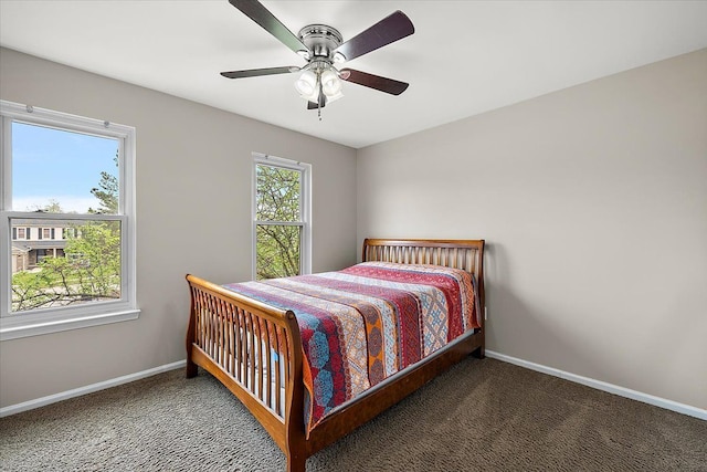 carpeted bedroom featuring ceiling fan and baseboards