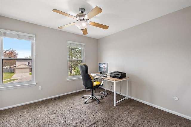 carpeted home office with baseboards and ceiling fan