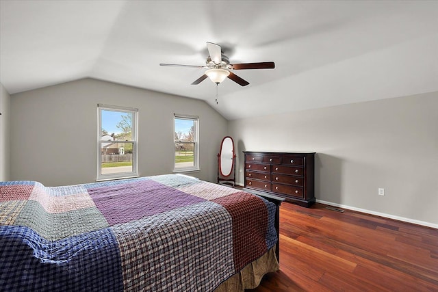 bedroom with a ceiling fan, vaulted ceiling, wood finished floors, and baseboards