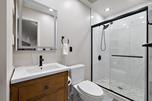 bathroom with vanity, toilet, and a stall shower