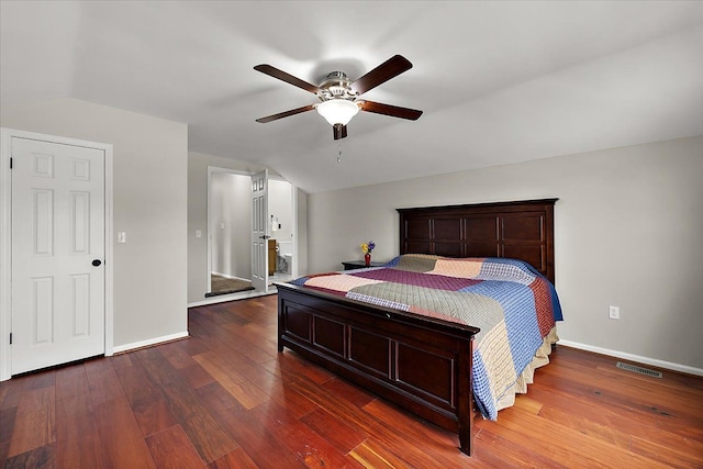 bedroom with baseboards, visible vents, and wood finished floors