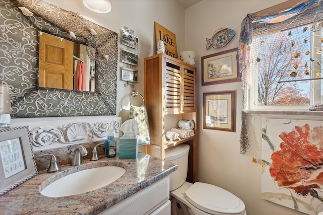 bathroom featuring toilet, curtained shower, and vanity