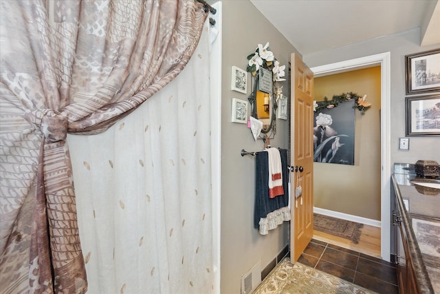 bathroom with tile patterned floors, vanity, visible vents, and baseboards