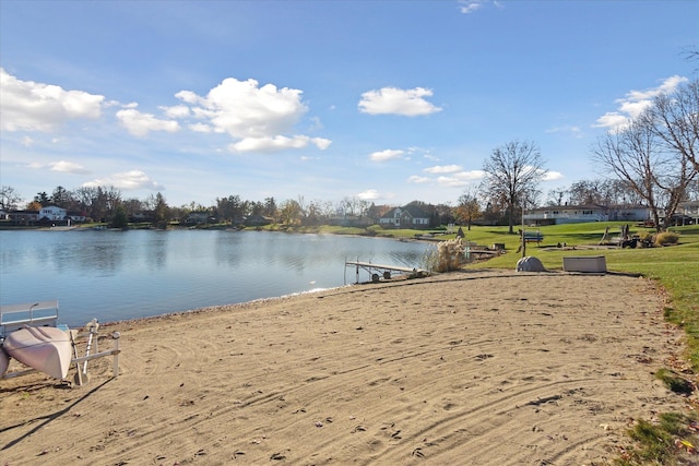 dock area featuring a water view and a lawn