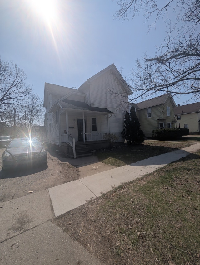 view of side of home with covered porch