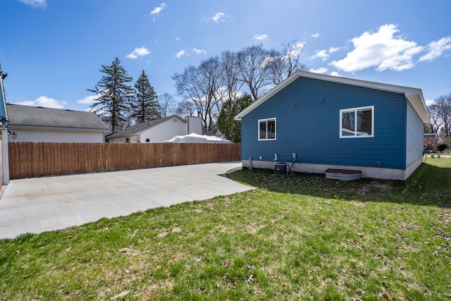 back of property featuring a patio, a yard, central AC unit, and fence