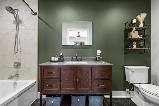 full bathroom with baseboards, toilet, ceiling fan, vanity, and shower / tub combination