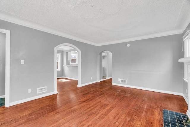 13955 Prevost St, Detroit, MI 48227 - unfurnished living room featuring visible vents, arched walkways, and wood finished floors