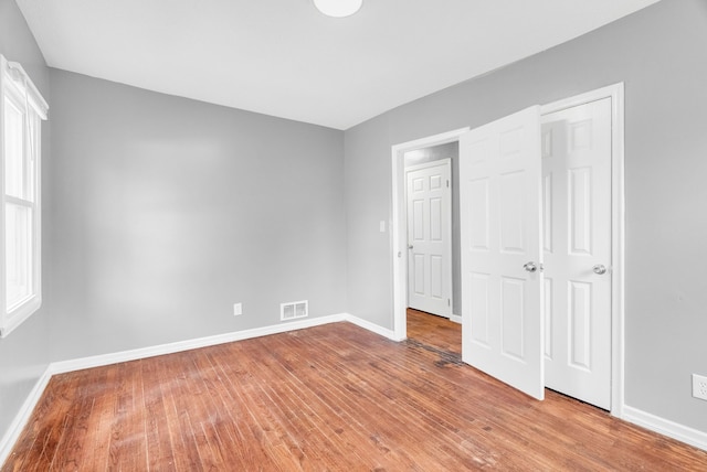 13955 Prevost St, Detroit, MI 48227 - unfurnished bedroom featuring visible vents, baseboards, and hardwood / wood-style floors
