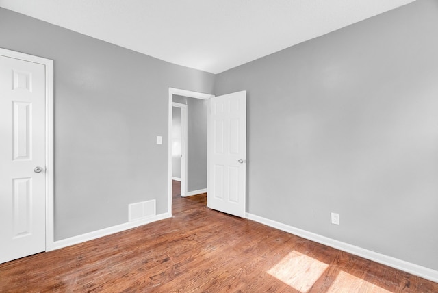 13955 Prevost St, Detroit, MI 48227 - unfurnished bedroom with visible vents, baseboards, and wood finished floors