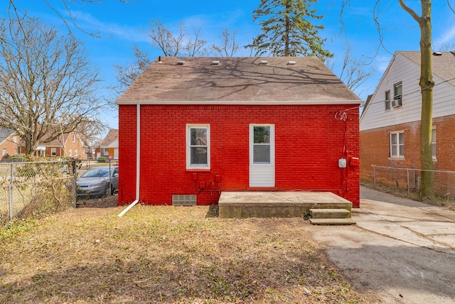 13955 Prevost St, Detroit, MI 48227 - rear view of house with brick siding, a fenced backyard, and a patio area