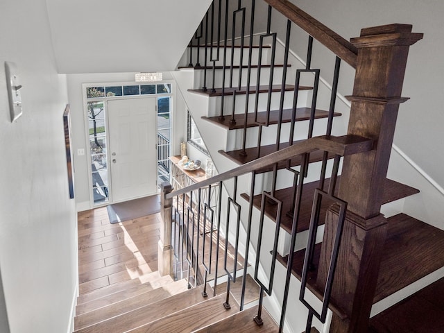 staircase with baseboards and wood finished floors
